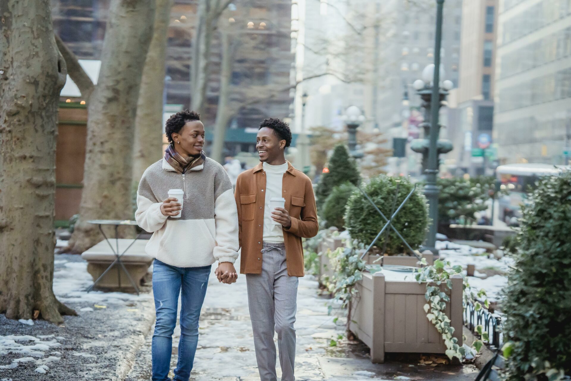 Two people walking down the street