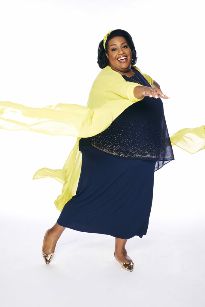 Alison Hammond wearing a black dress and yellow shawl