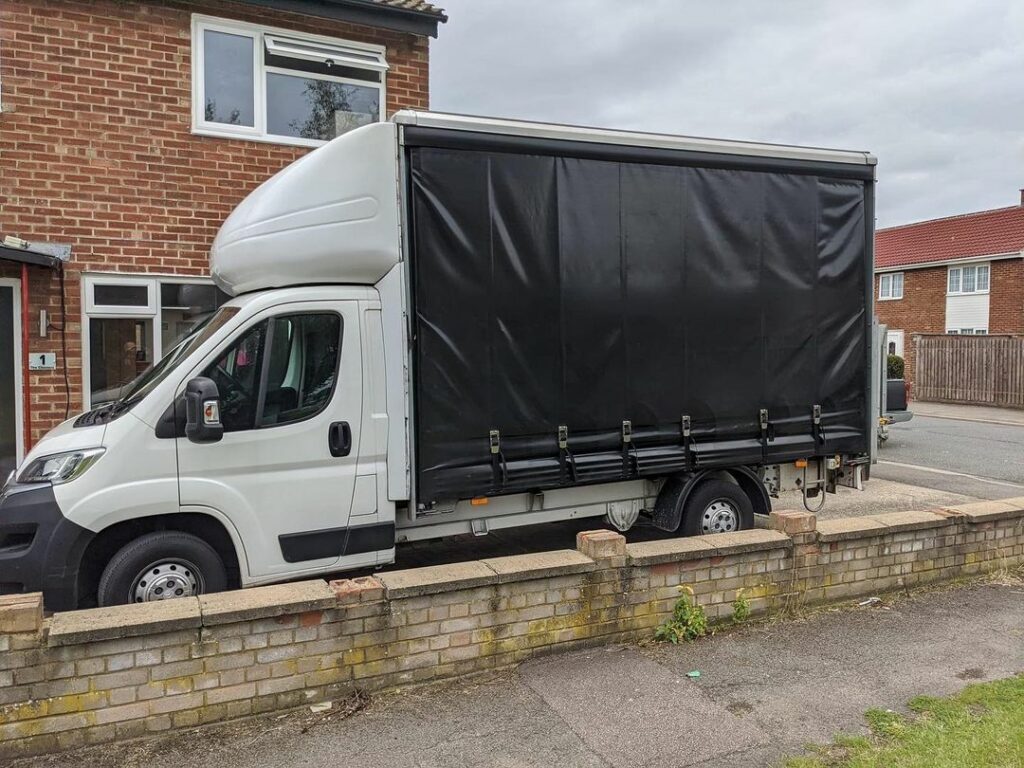 A luton van sitting outside a house