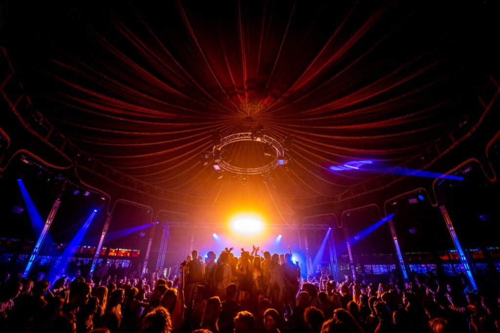 People dancing in a circus style tent