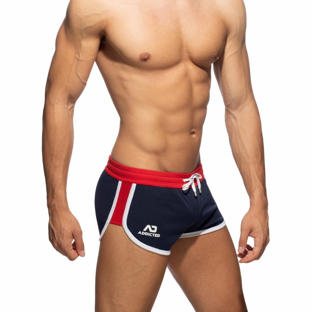 Male model wearing black and red shorts