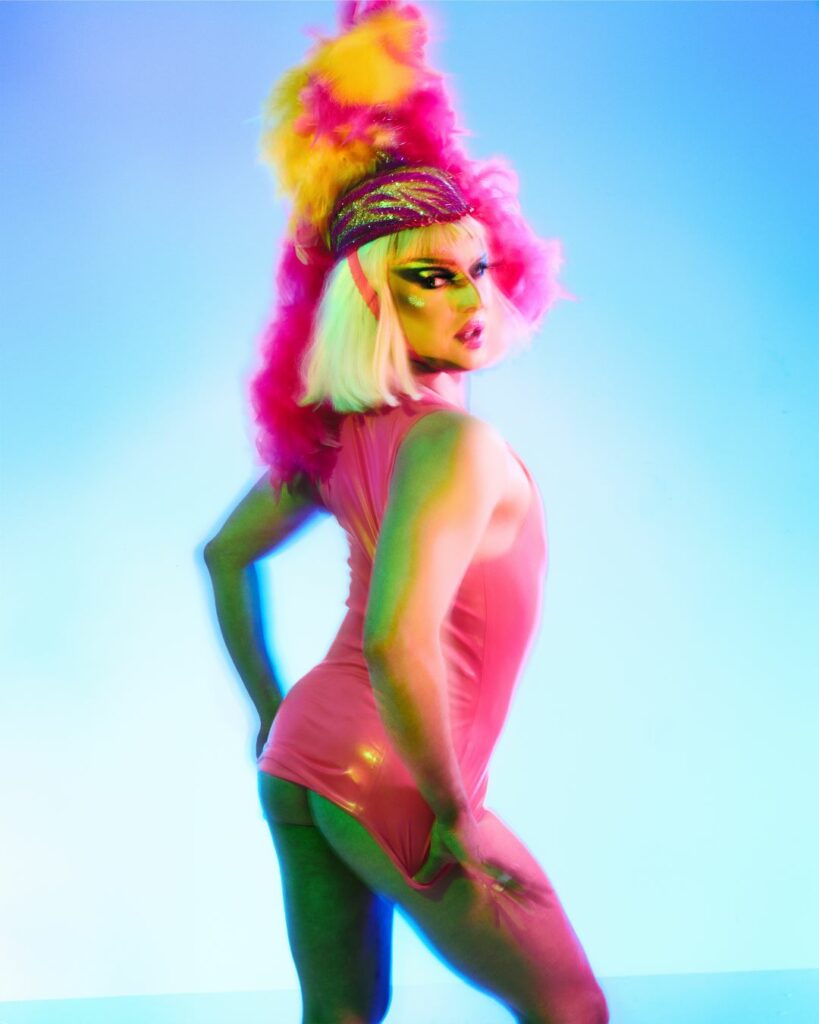 Stylised image of a drag artist against a gradient backdrop