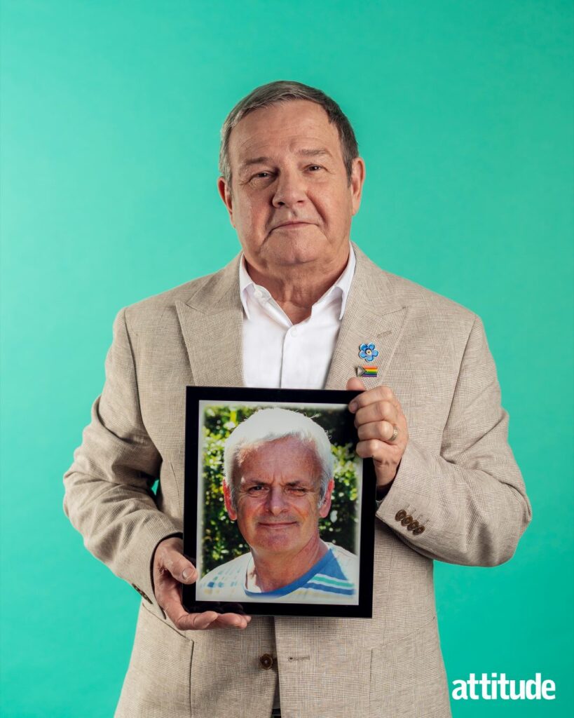 Mike Parish holding a photo of his husband Tom