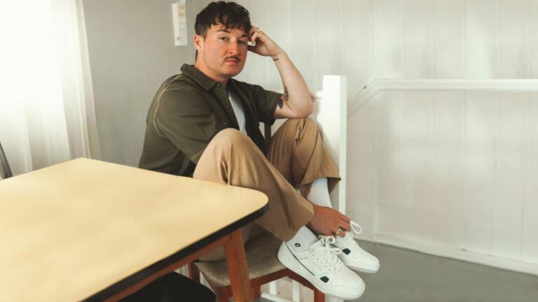 Max Siegel modelling a pair of white Skechers trainers
