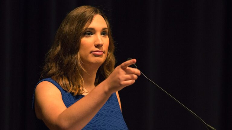 Sarah McBride standing before a microphone