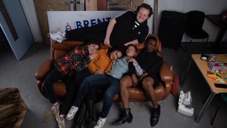 The team behind Big Boys lying on a sofa
