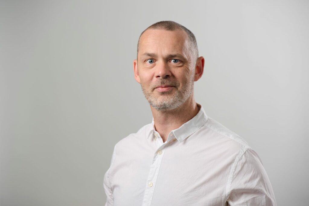 Smiling man in a white shirt