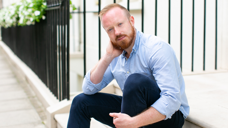 The author sitting on some steps wearing a blue shirt (Image: Annel Marinovich Photography)