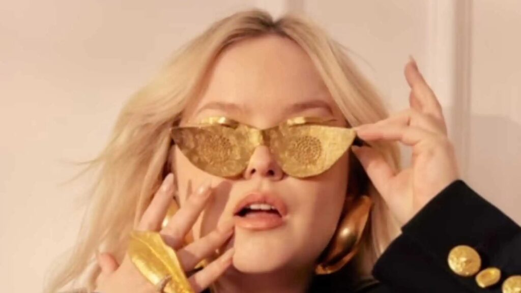 Nicola Coughlan in a pair of gold sunglasses