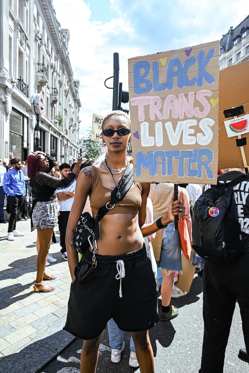 an attendee holding a sign saying 'Black trans lives matter'