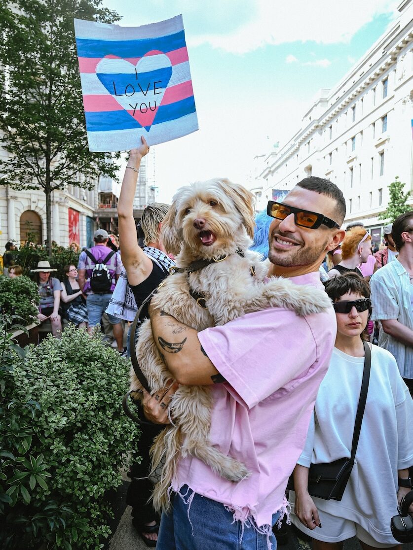 An attendee holding a dog in their arms