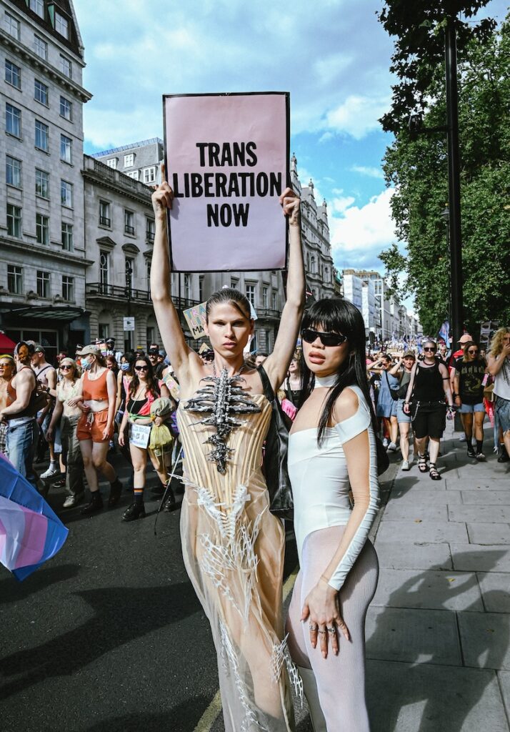 more marchers, this time holding a sign saying 'trans liberation now'