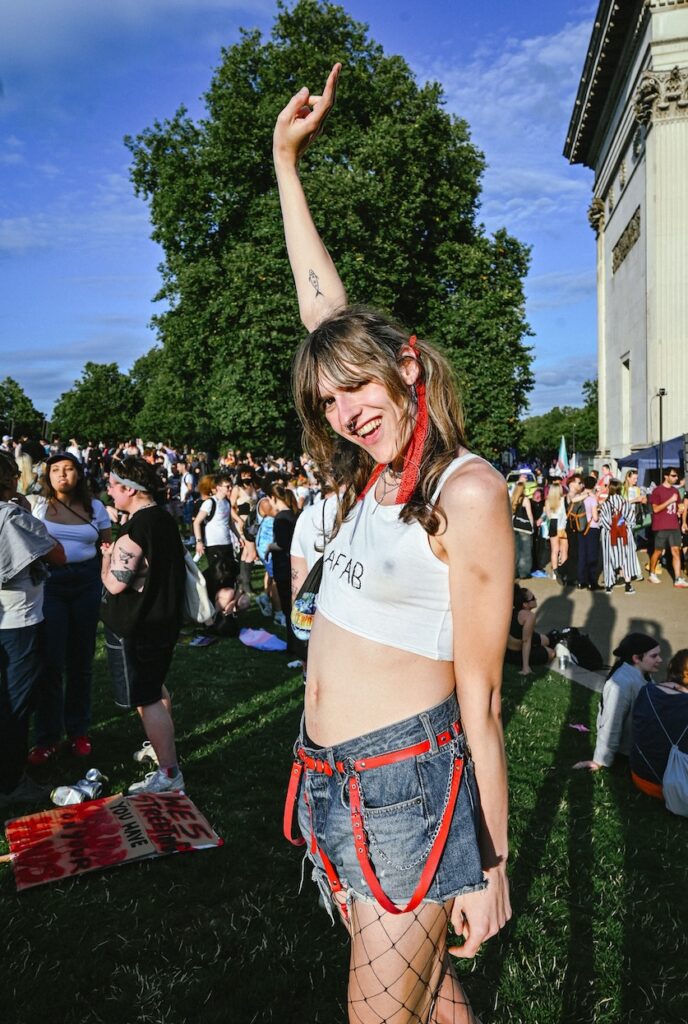 another attendee, wearing a top with the words 'AFAB' strikes a pose in Hyde Park