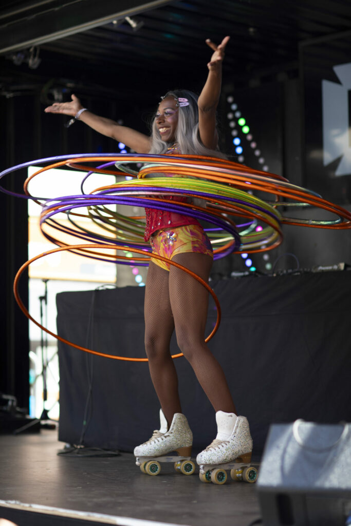 A person hula-hooping in roller skates