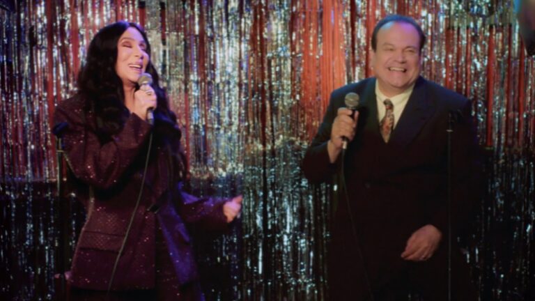 Cher and Shaun Williamson, who played Barry in EastEnders, singing karaoke