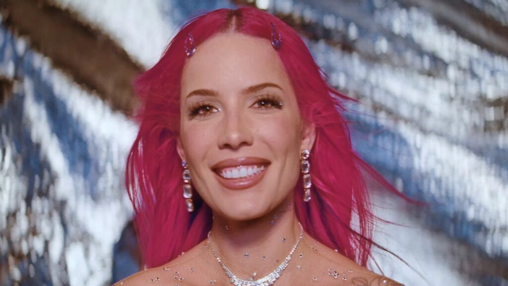 Halsey in her music video for 'Lucky', in a pink wig against a silver background