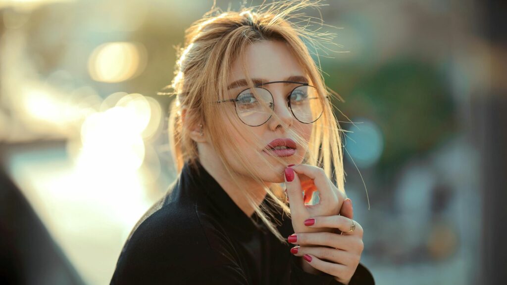 Woman with a black blazer wearing glasses