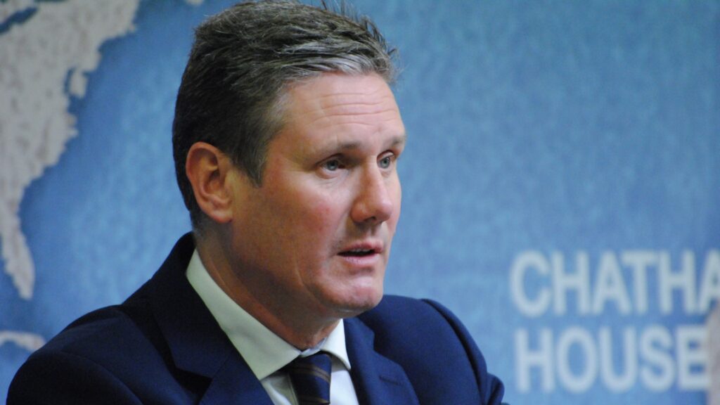 Keir Starmer pictured against a blue background