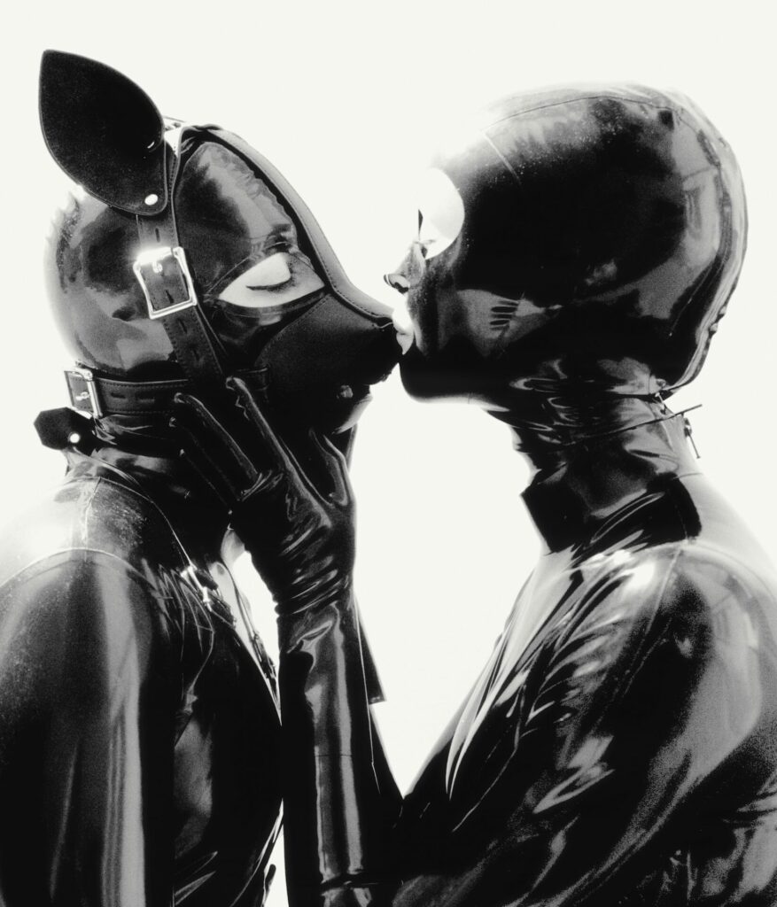 two people in latex gear kissing