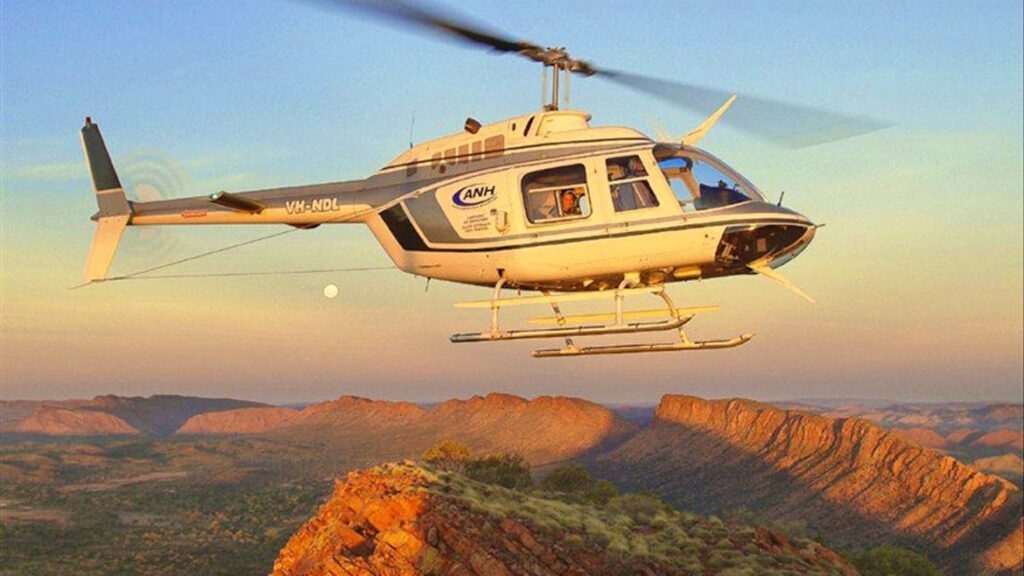 A helicopter flies over Alice Springs