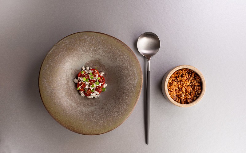 A plate and bowl of food and a spoon