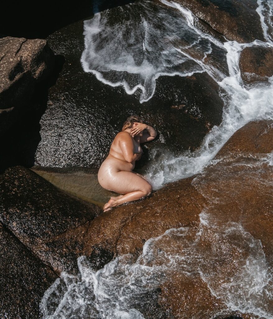 a person posing naked in some surf