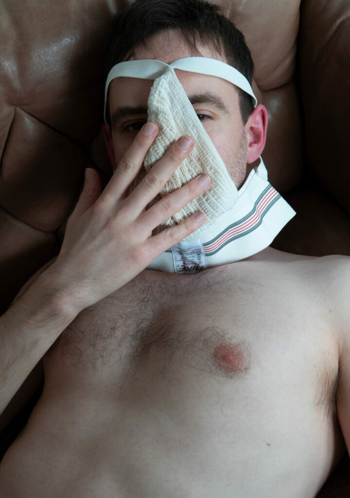 a subject topless with a jockstrap over their face