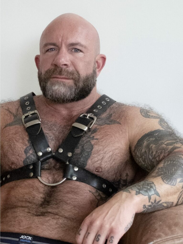 A bearded subject wearing a harness