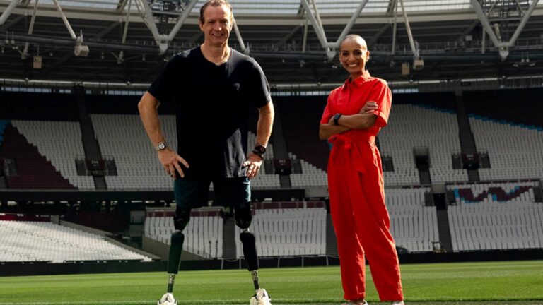 Richard Whitehead and Adele Roberts standing in a sports stadiun