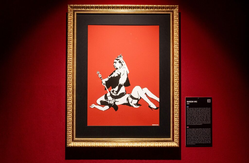 A Banksy painting of Queen Victoria sitting on a woman's face