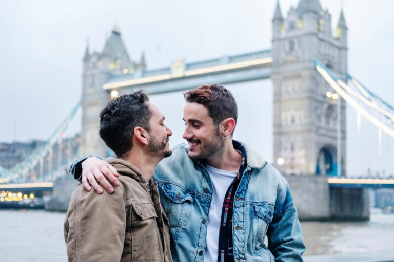 Two men embrace each other in front of London's Tower Bridge