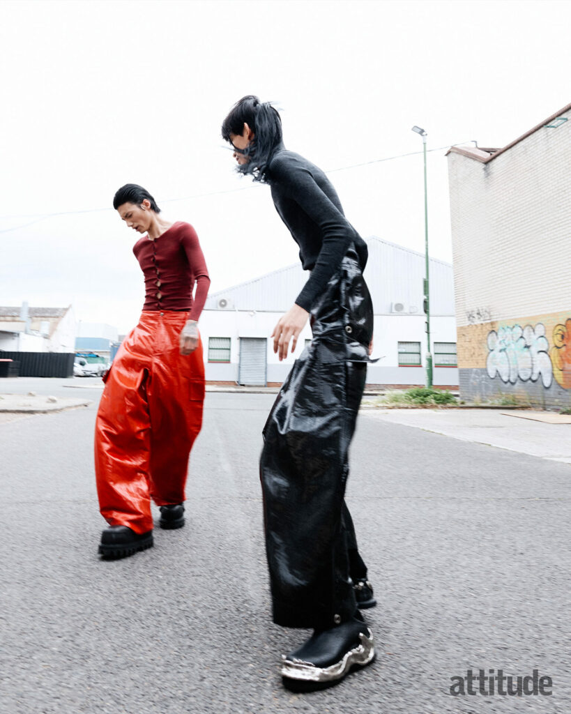 Models wear tight knit tops and large parachute trousers in red/black by McQueen 