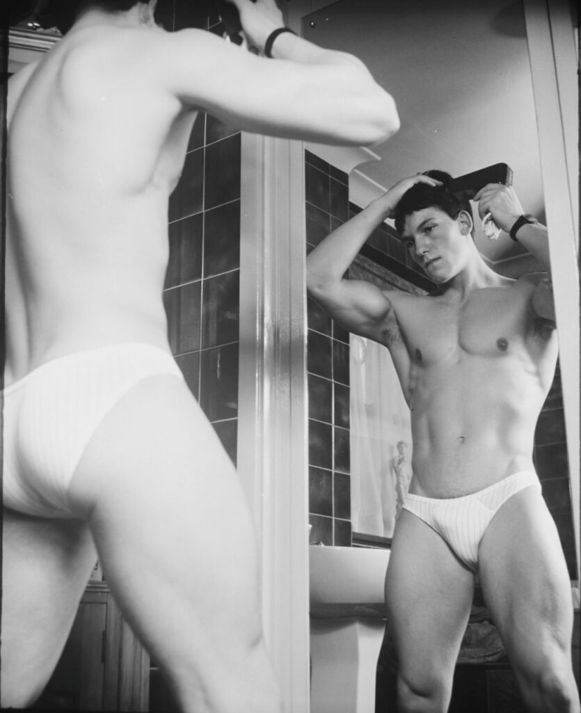 Black and white image of a man wearing underwear