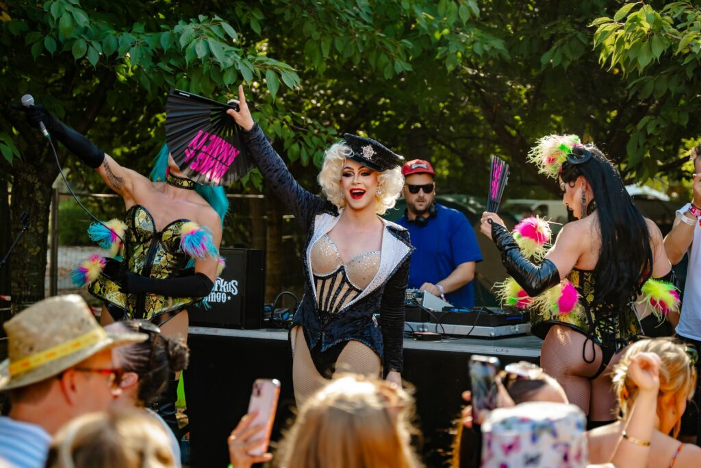 Drag performers in front of a crowd