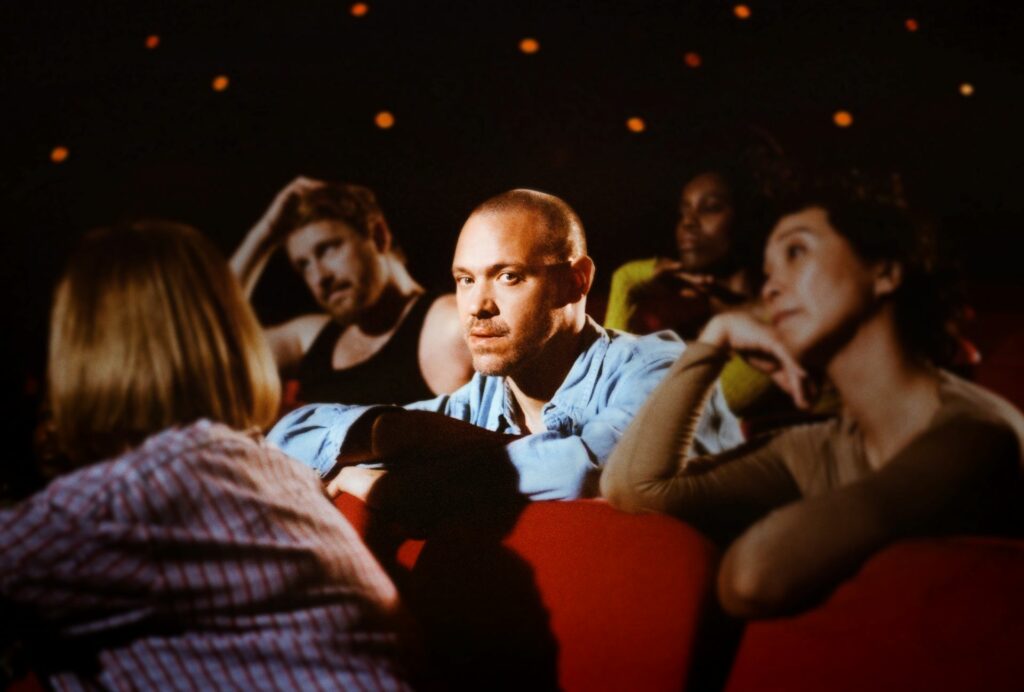 Will Young sitting in a cinema surrounded by people