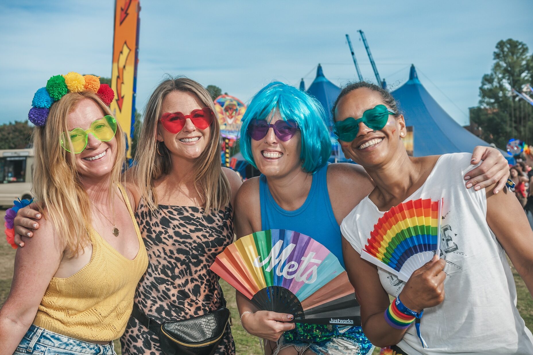 Four friends, including one in a blue wig, pose at Fabuloso