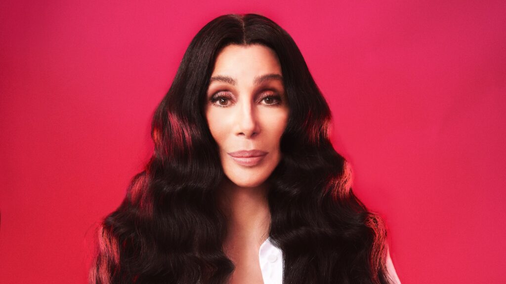 A head and shoulders of Cher against a red backdrop (Image: An Le)