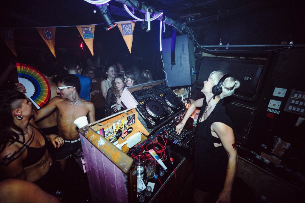 A DJ playing music in a nightclub