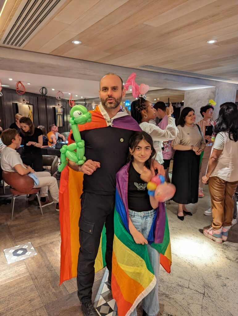 A man hugs a girl at a Pride event