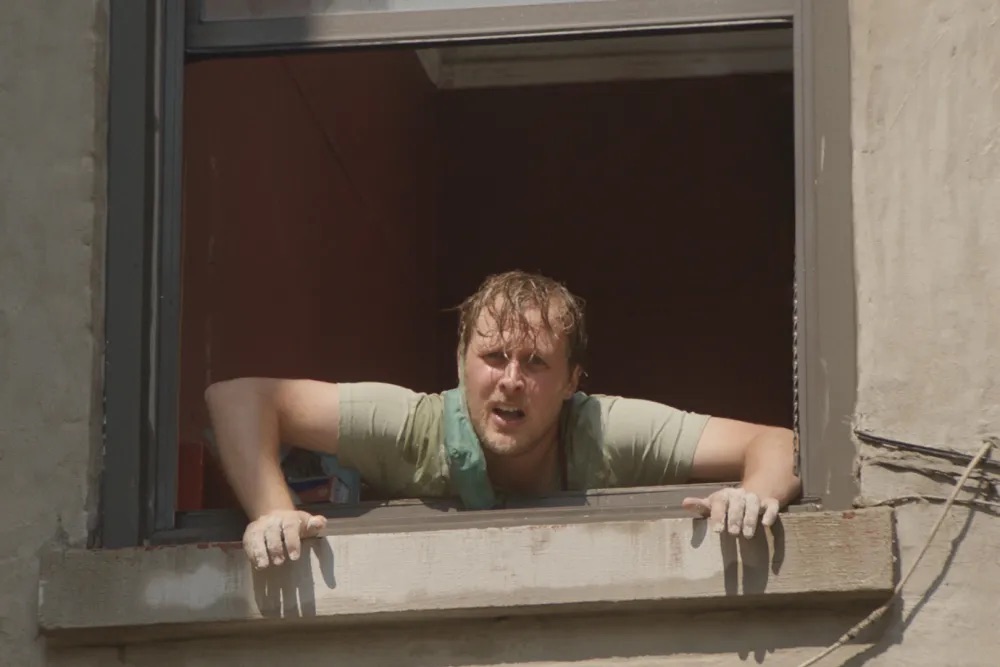 a person with wet hair peering through a window