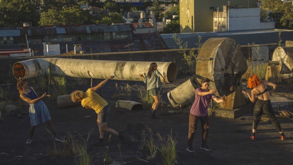 a group of people dancing in an industrial park