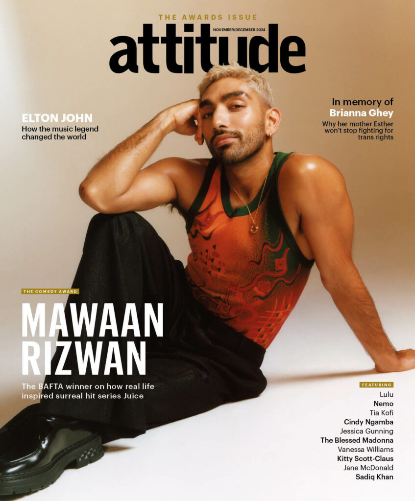 Mawaan Rizwan posing on the ground in an orange tank top and black trousers on the cover of Attitude Magazine