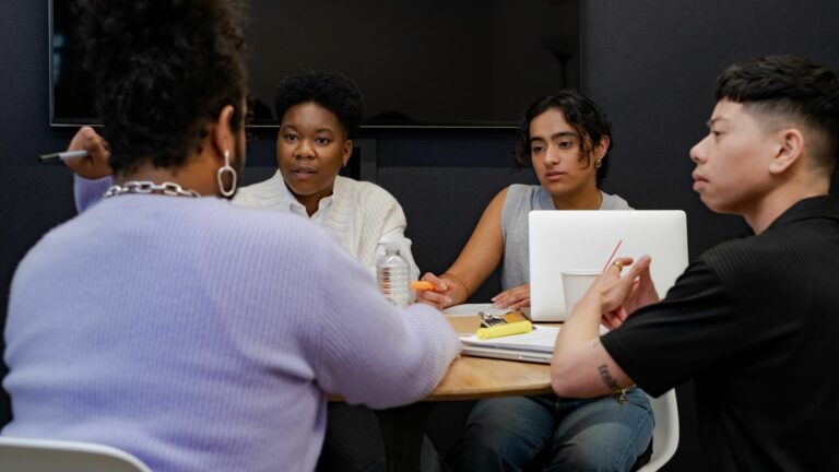 A group of co-workers of varying genders having a meeting