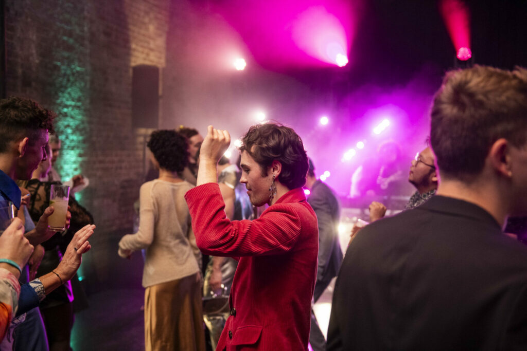 Misia Butler in a red suit dancing