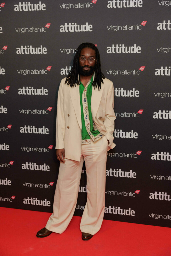 Nathan Stewart-Jarrett in a white suit and green shirt