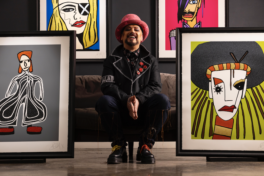 Boy George surrounded by his portraits