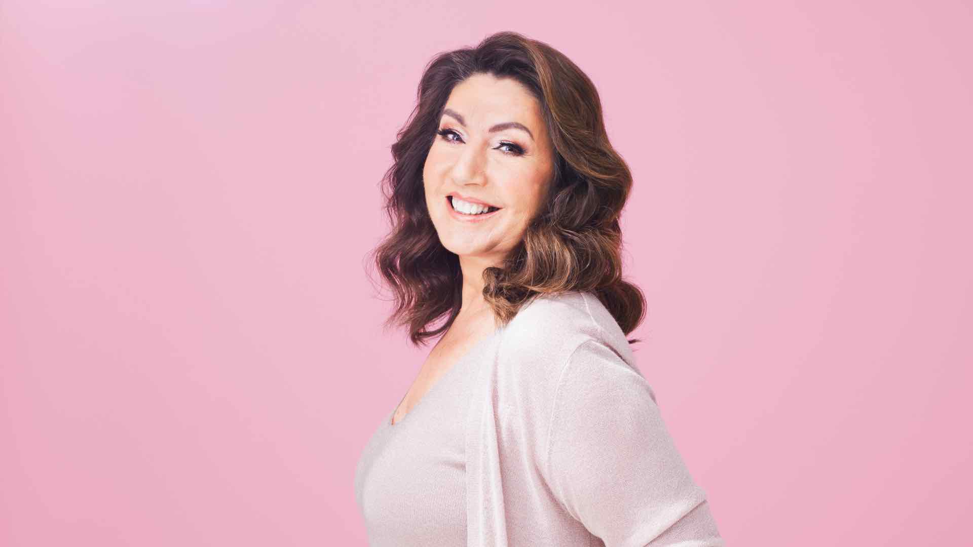 Jane McDonald against a pink backdrop