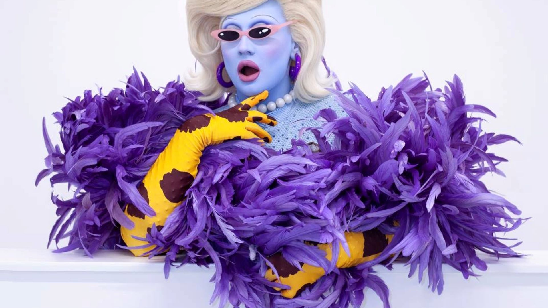 Juno Birch wearing purple feathers