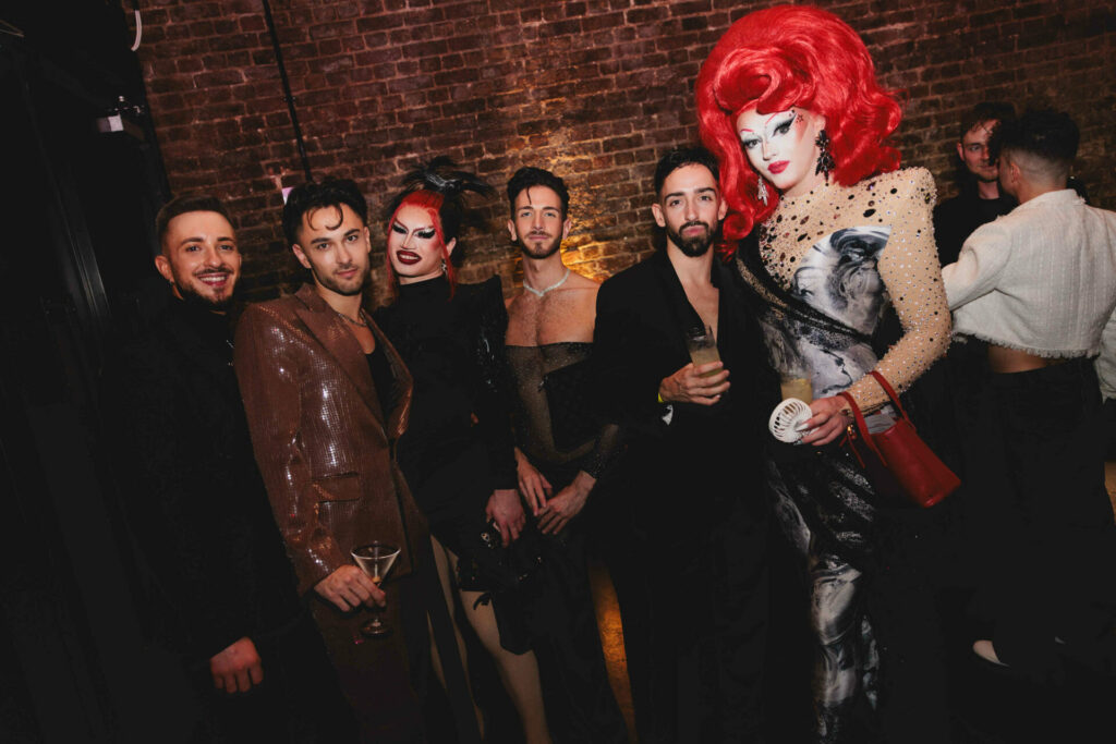 Drag race stars Charra Tea and Actavia with a group of men