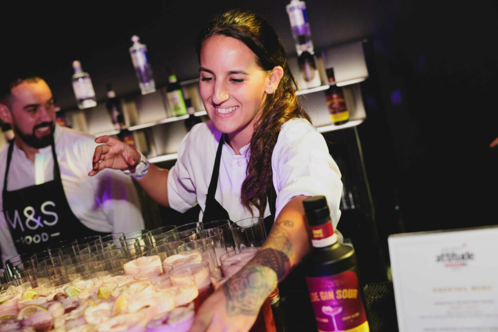 A woman behind the bar serving drinks